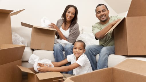 Family unpacking boxes moving house