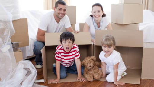 family moving house surrounded by boxes